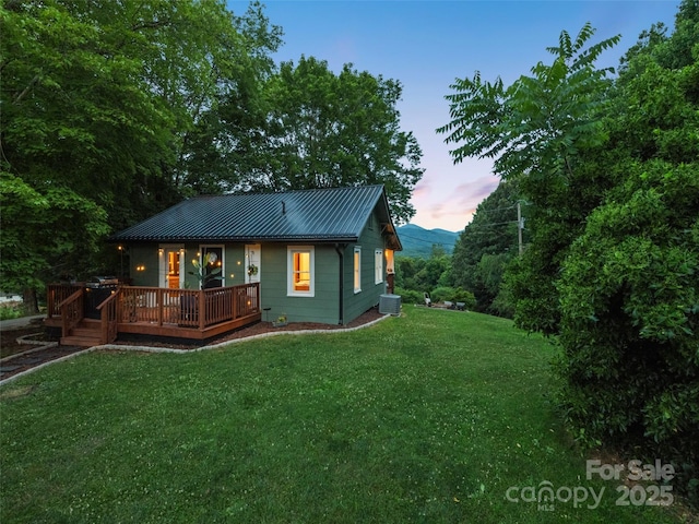 68 Piney Mountain Church Rd, Candler, NC 28715 - rear view of house with a lawn, a wooden deck, central AC, and metal roof