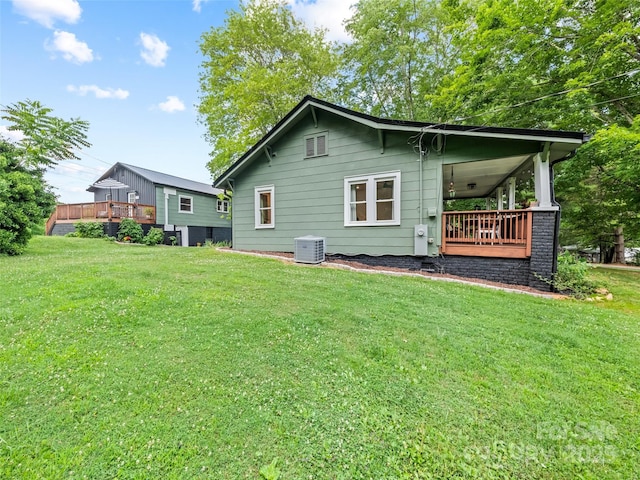68 Piney Mountain Church Rd, Candler, NC 28715 - rear view of property featuring a lawn, central AC, and covered porch