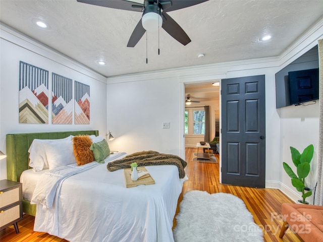 68 Piney Mountain Church Rd, Candler, NC 28715 - bedroom with baseboards, ornamental molding, ceiling fan, and wood finished floors