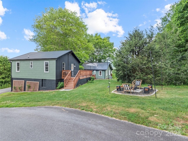 68 Piney Mountain Church Rd, Candler, NC 28715 - view of front of property featuring a garage, a wooden deck, stairway, a front yard, and a fire pit