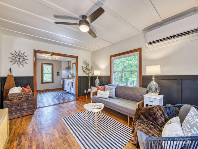 68 Piney Mountain Church Rd, Candler, NC 28715 - living area featuring plenty of natural light, a ceiling fan, wainscoting, and a wall mounted AC