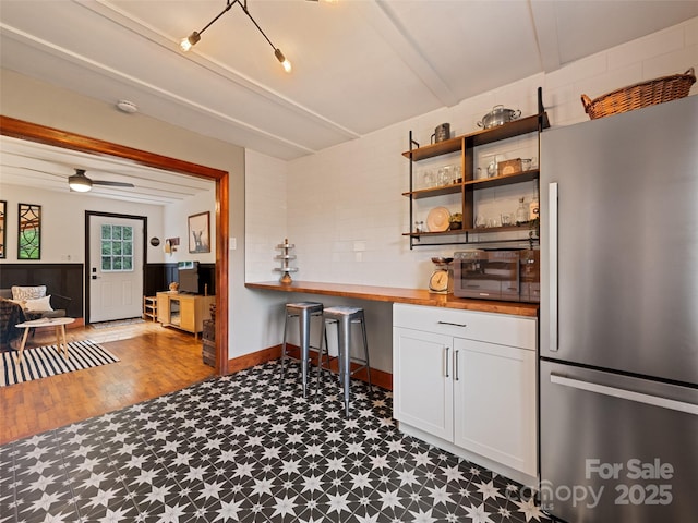 68 Piney Mountain Church Rd, Candler, NC 28715 - kitchen with white cabinets, open shelves, tile patterned floors, wood counters, and freestanding refrigerator