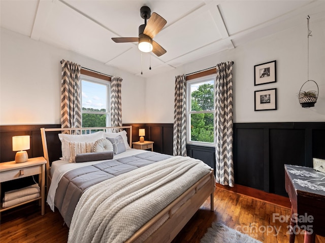68 Piney Mountain Church Rd, Candler, NC 28715 - bedroom with multiple windows, hardwood / wood-style flooring, and a wainscoted wall