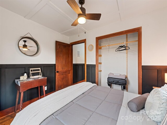 68 Piney Mountain Church Rd, Candler, NC 28715 - bedroom featuring wood finished floors, wainscoting, ceiling fan, and a decorative wall