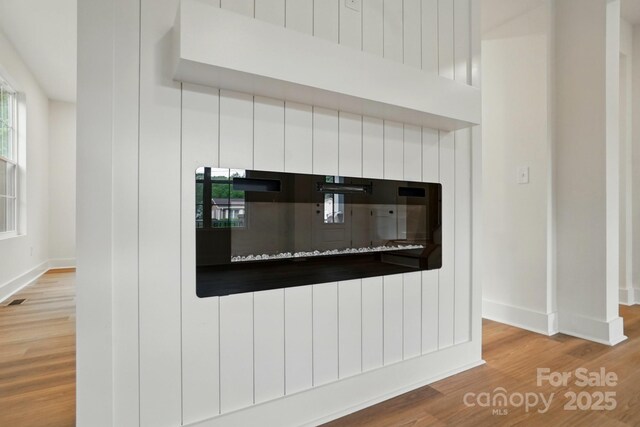 room details with baseboards and wood finished floors