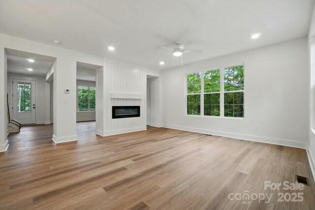 unfurnished living room with visible vents, a ceiling fan, light wood-style flooring, and recessed lighting
