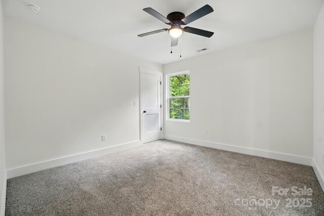 spare room featuring baseboards, ceiling fan, carpet flooring, and visible vents