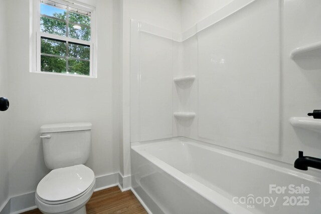 full bathroom with toilet, baseboards, and wood finished floors