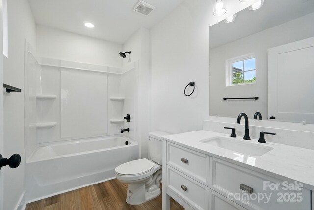 full bath with shower / tub combination, vanity, toilet, wood finished floors, and visible vents