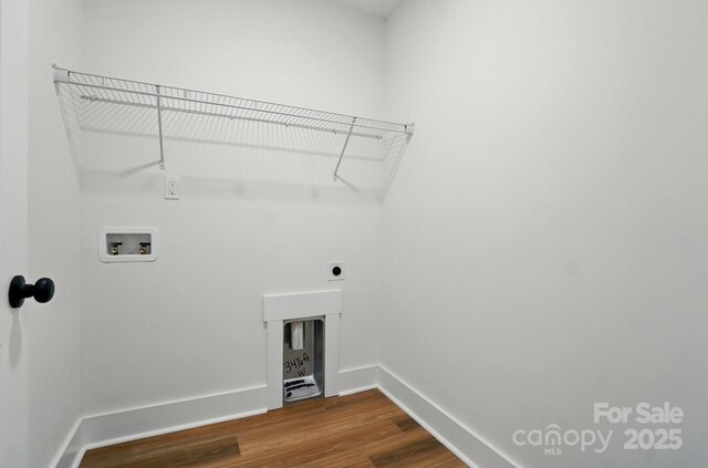 washroom featuring laundry area, washer hookup, baseboards, electric dryer hookup, and dark wood-style floors