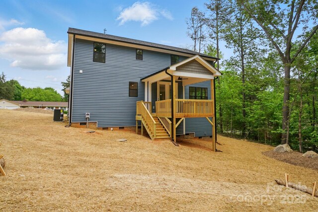 rear view of property with a ceiling fan, stairway, crawl space, and a deck