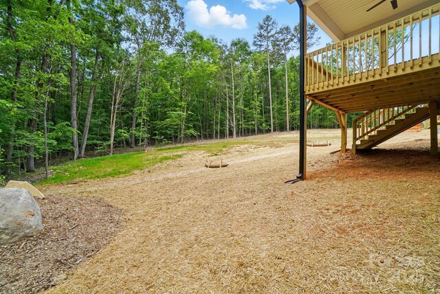 view of yard with stairway and a deck