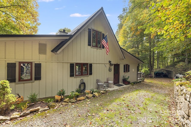 197 Gardenside Rd, Mars Hill, NC 28754 - view of property exterior featuring a detached carport, a chimney, driveway, and board and batten siding