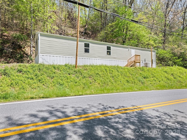 700 Cove Creek Rd, Waynesville, NC 28785 - view of front of home with a forest view and central AC