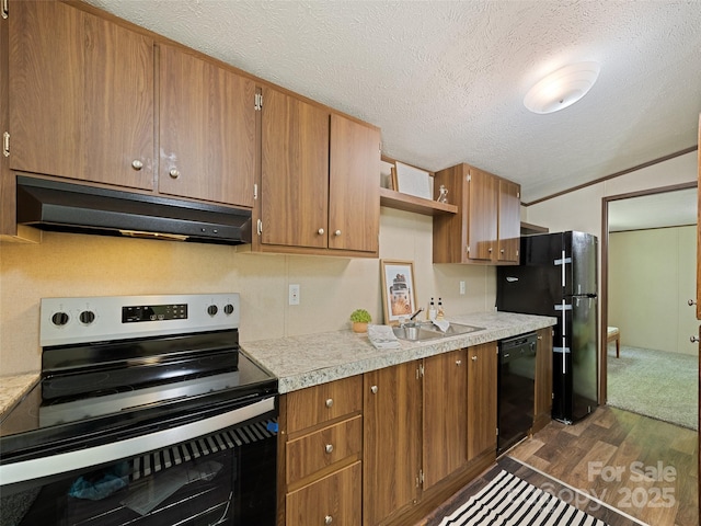 700 Cove Creek Rd, Waynesville, NC 28785 - kitchen featuring dark wood-style flooring, a textured ceiling, under cabinet range hood, a sink, and black appliances