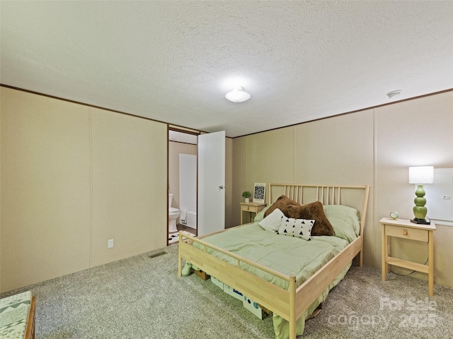 700 Cove Creek Rd, Waynesville, NC 28785 - bedroom featuring visible vents, a textured ceiling, carpet, and ensuite bathroom