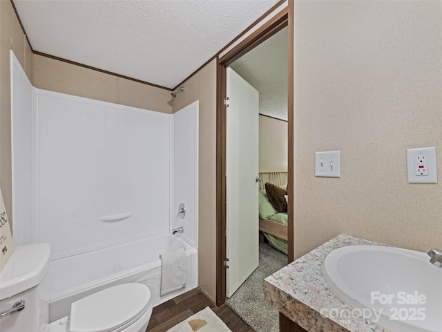 700 Cove Creek Rd, Waynesville, NC 28785 - full bathroom with a textured ceiling, wood finished floors, vanity, toilet, and bathing tub / shower combination