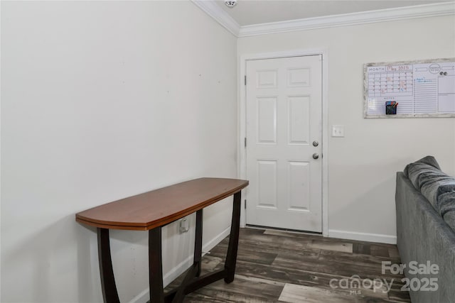 doorway with baseboards, ornamental molding, and wood finished floors
