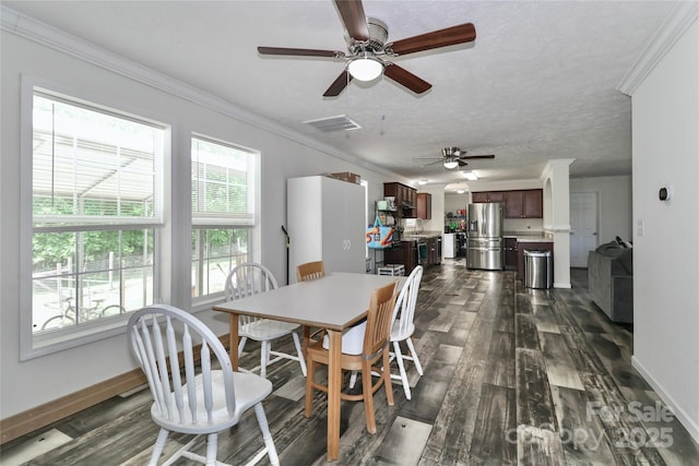 dining space with crown molding, a ceiling fan, visible vents, and dark wood-style floors