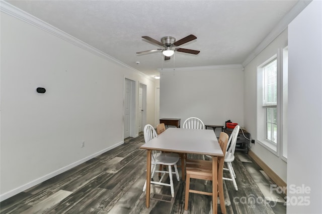 dining area featuring baseboards, dark wood-style flooring, a ceiling fan, and a wealth of natural light