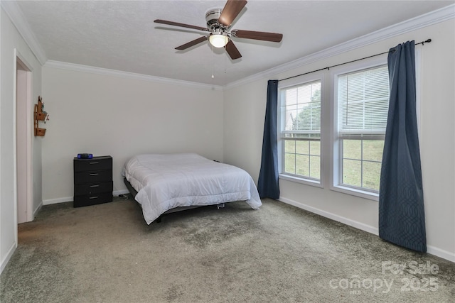 carpeted bedroom featuring crown molding, baseboards, and ceiling fan
