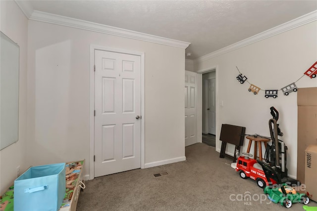 game room with crown molding, carpet flooring, visible vents, and baseboards