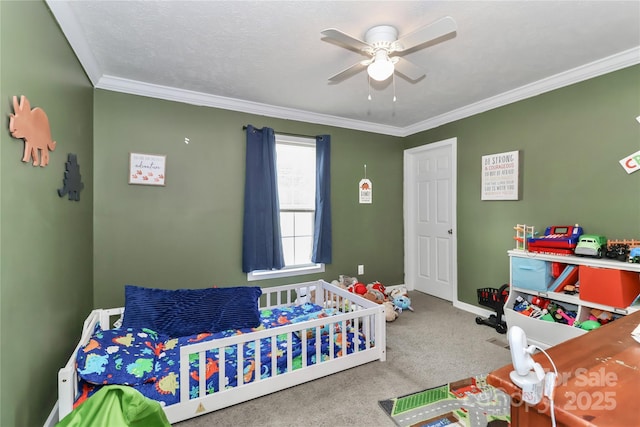 carpeted bedroom with crown molding, baseboards, and a ceiling fan