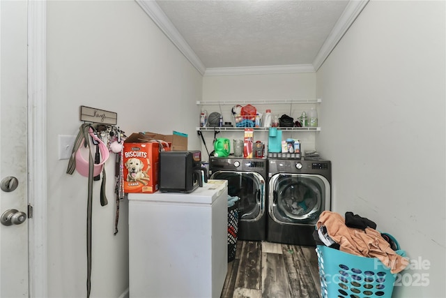 laundry room with crown molding, laundry area, wood finished floors, and washer and dryer