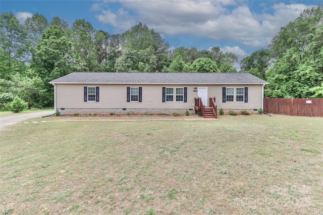 view of front of home with crawl space, fence, and a front lawn
