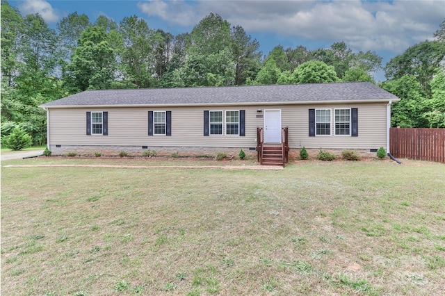 manufactured / mobile home featuring a front lawn, fence, and crawl space