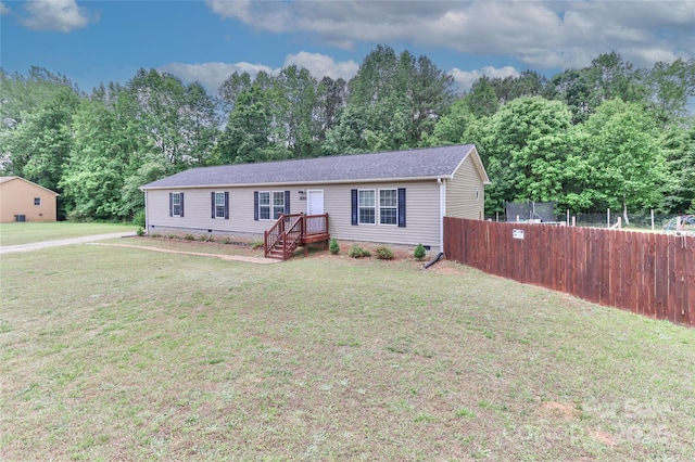 manufactured / mobile home featuring fence, crawl space, and a front yard