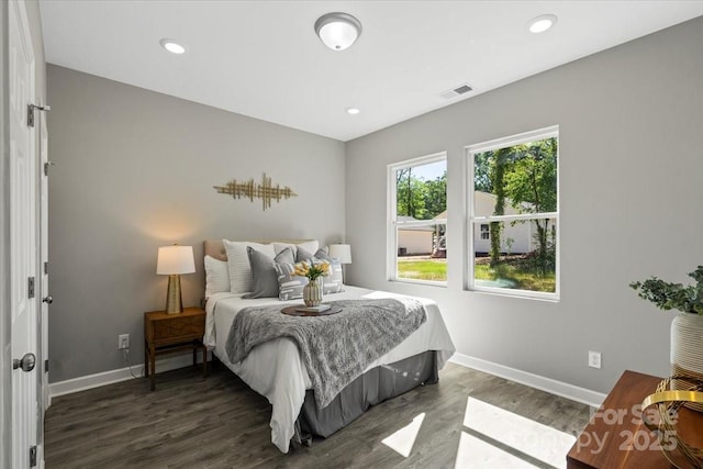 bedroom featuring baseboards, recessed lighting, wood finished floors, and visible vents