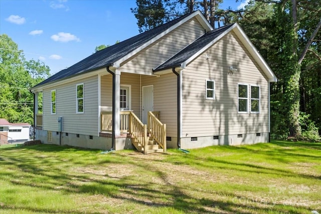 rear view of property with a lawn and crawl space