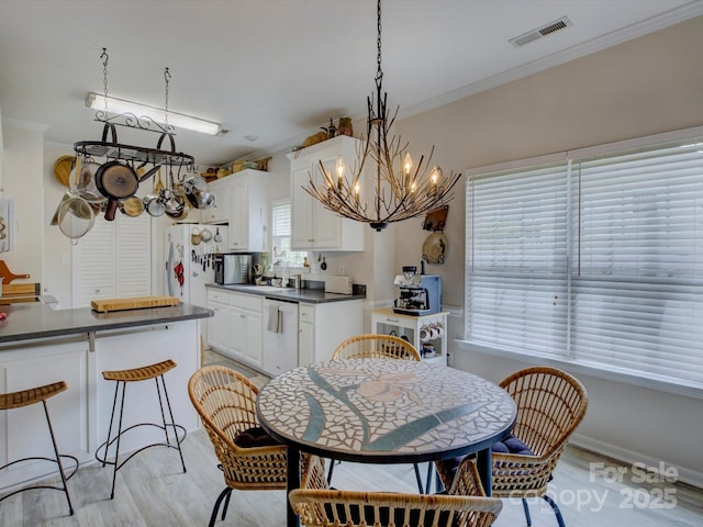 433 Linsbury Ct, Gastonia, NC 28056 - dining area with visible vents, ornamental molding, light wood-style floors, and a chandelier