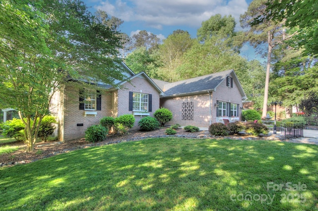 ranch-style house with brick siding, crawl space, and a front yard