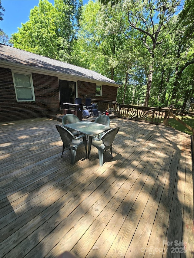 wooden deck with outdoor dining space
