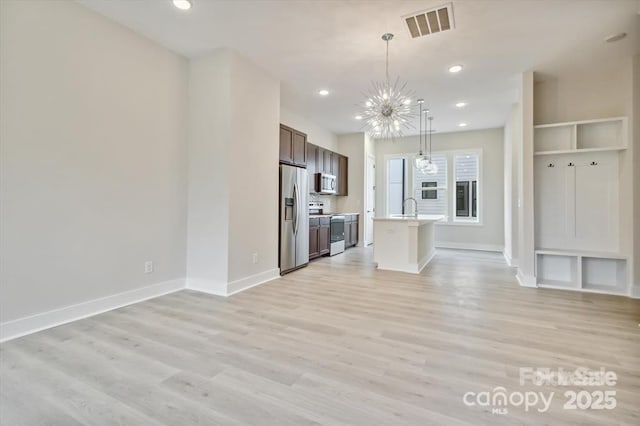 842 Van Every St, Charlotte, NC 28205 - unfurnished living room featuring a notable chandelier, a sink, baseboards, light wood-type flooring, and visible vents