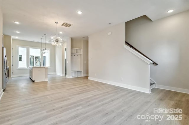 842 Van Every St, Charlotte, NC 28205 - unfurnished living room with an inviting chandelier, recessed lighting, light wood-type flooring, and visible vents