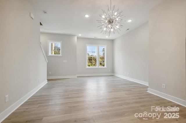 842 Van Every St, Charlotte, NC 28205 - spare room featuring baseboards, recessed lighting, light wood-style flooring, and a chandelier