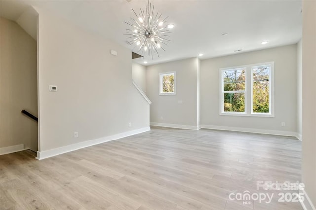 842 Van Every St, Charlotte, NC 28205 - unfurnished living room featuring an inviting chandelier, baseboards, recessed lighting, and light wood finished floors
