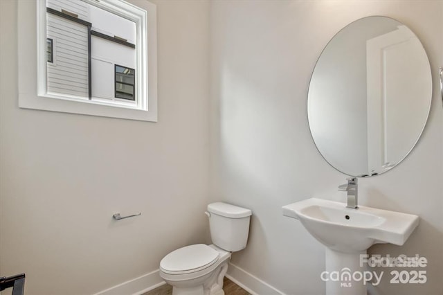 842 Van Every St, Charlotte, NC 28205 - half bath featuring toilet, baseboards, and wood finished floors