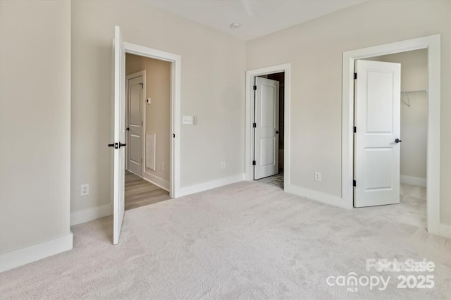 842 Van Every St, Charlotte, NC 28205 - unfurnished bedroom featuring baseboards, carpet flooring, and a spacious closet