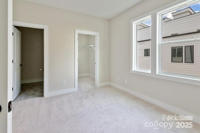 842 Van Every St, Charlotte, NC 28205 - unfurnished bedroom featuring a closet, baseboards, carpet flooring, and a spacious closet