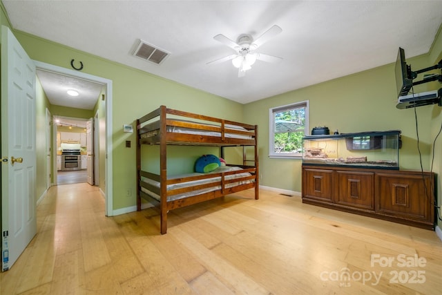 bedroom with light wood-style floors and baseboards