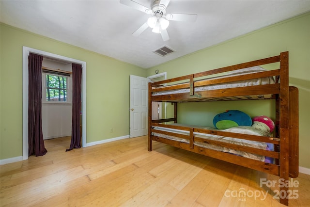 bedroom with wood finished floors and baseboards