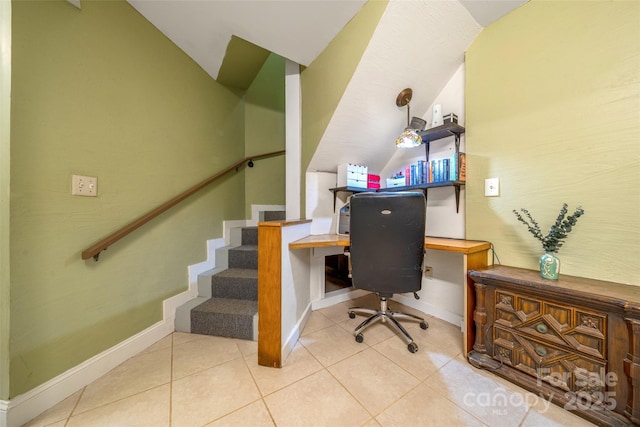 office area with vaulted ceiling, baseboards, and tile patterned floors