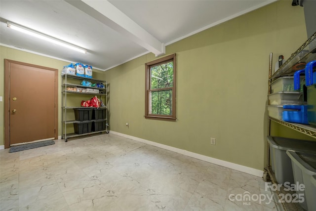 unfurnished room with ornamental molding, baseboards, and marble look tile flooring