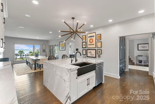 kitchen with light stone countertops, a sink, dishwasher, recessed lighting, and a center island with sink