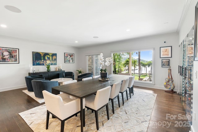 dining room featuring baseboards, ornamental molding, recessed lighting, and wood finished floors