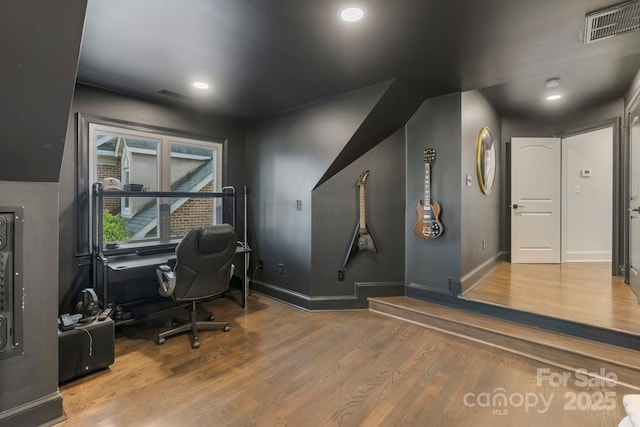office area featuring baseboards, wood finished floors, and visible vents